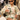 Woman wearing a two piece short set in the city haviing a cup of coffee outside.