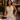 Women wearing a halter pleated maxi dress at a restaurant in the city.