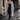 Woman wearing the YAHKARA Soho Hooded Cardigan in gray with a black scoop-neck top, black leggings, and sneakers while walking through SoHo NYC holding a coffee.